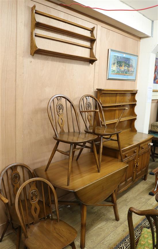 An Ercol six piece dining room suite consisting of four chairs, a drop leaf table, a sideboard and a plate rack sideboard W.123cm table